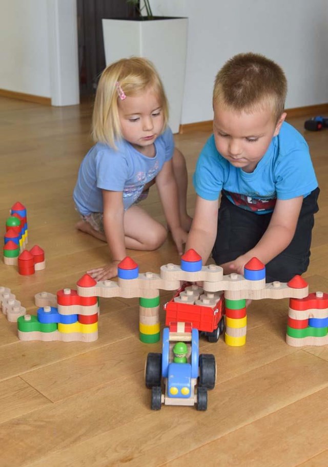 Zwei kleine Kinder spielen mit Bauklötzen